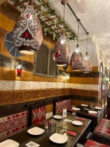 Traditional Syrian restaurant interior with decorative Arabic lanterns and patterned seating