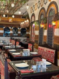 Traditional Syrian restaurant interior with Arabic décor, patterned seating and dining tables