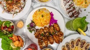 Halal chicken tikka served with aromatic biryani rice, grilled meat, salad, prawns and fresh mint drink