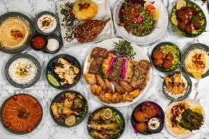 Middle Eastern mixed grill platter with hummus, falafel, salads, grilled chicken and mezze